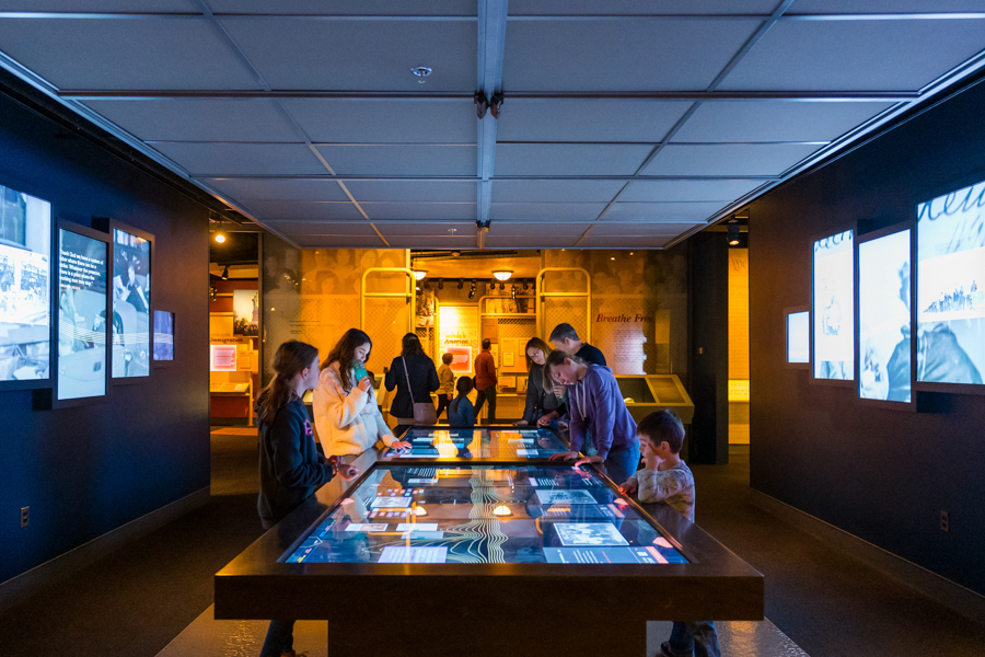 People gathered around table in National Archives 
