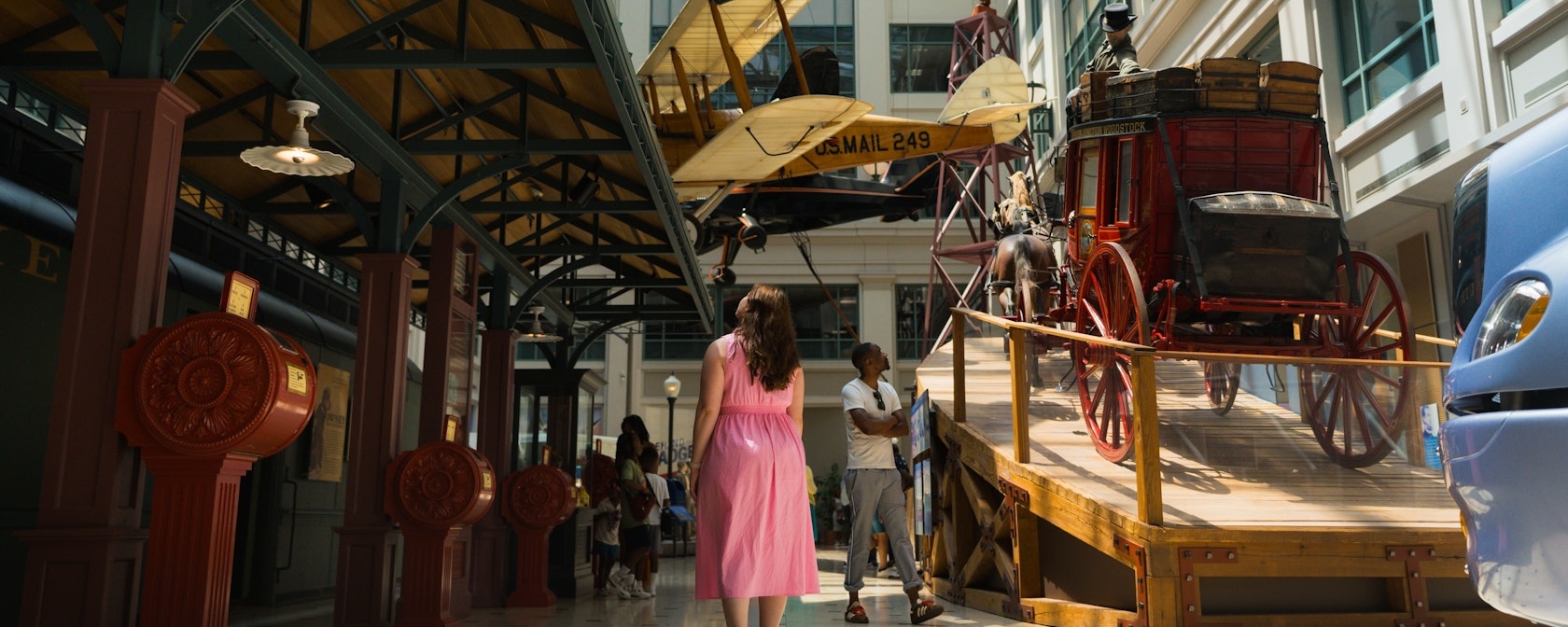 Visitors explore historic transportation displays inside the Smithsonian National Postal Museum.