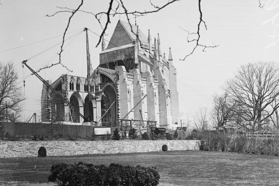 Historic photo of the Washington National Cathedral partially built with cranes and scaffolding.