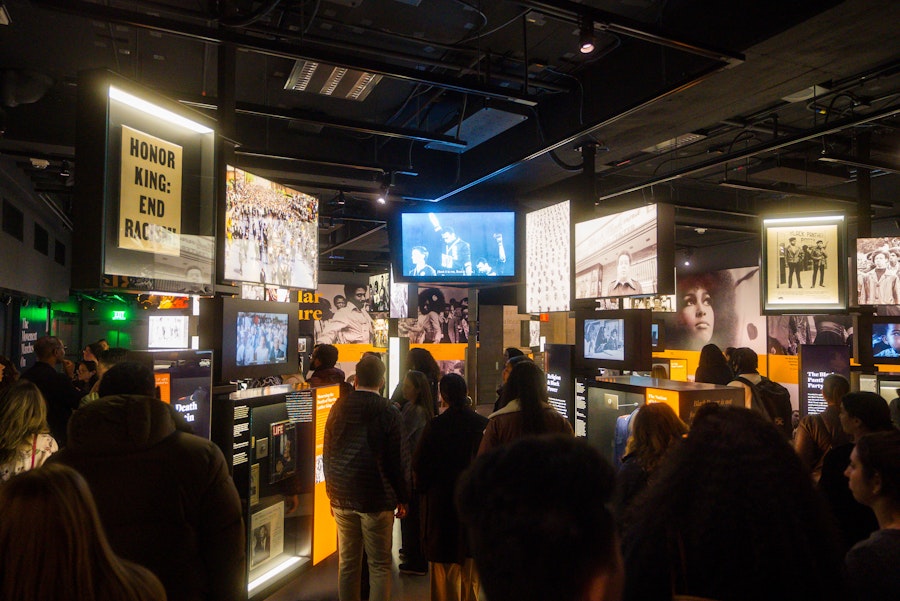 Visitors gathered in the civil rights gallery surrounded by historic photos, videos and signs.