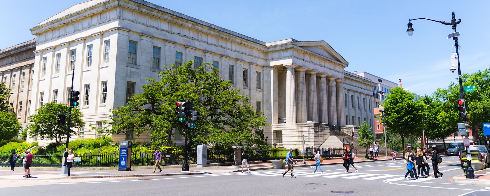 Pedestrians cross the street outside the National Portrait Gallery in Washington, DC.
