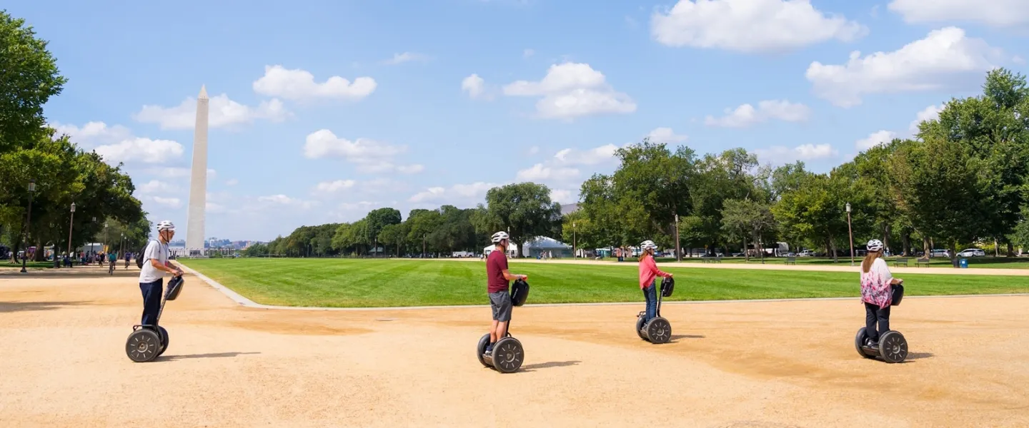 Group of people riding Segways on the National Mall with the Washington Monument in the background.