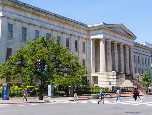Pedestrians cross the street outside the National Portrait Gallery in Washington, DC.